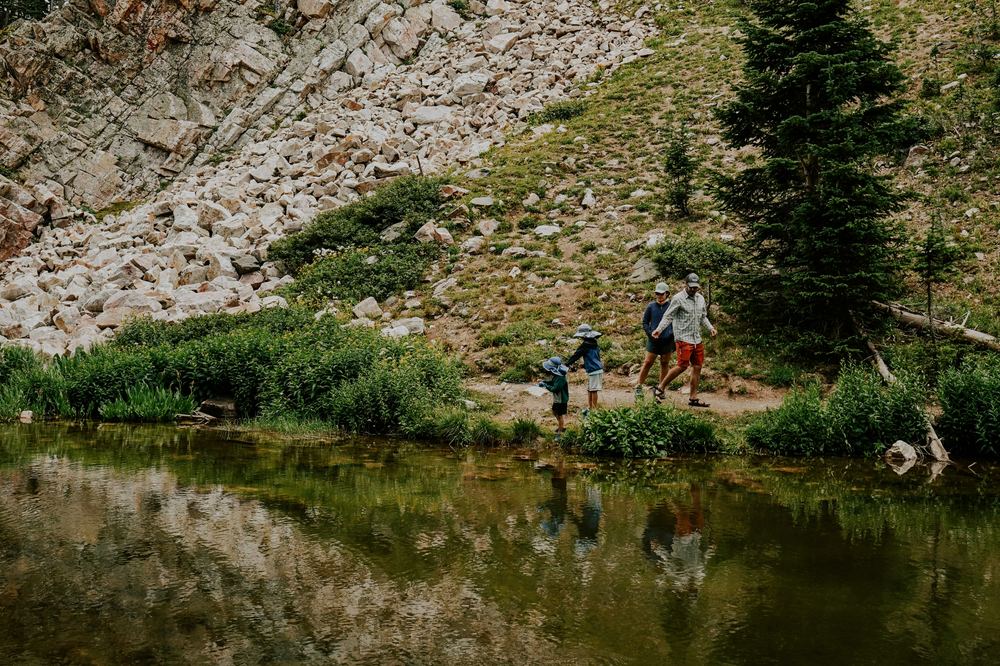 A family hiking by a mountain lake