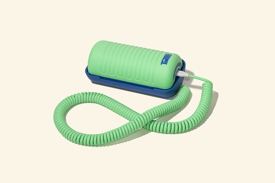 A green Tin Can kids' landline with a coiled cord